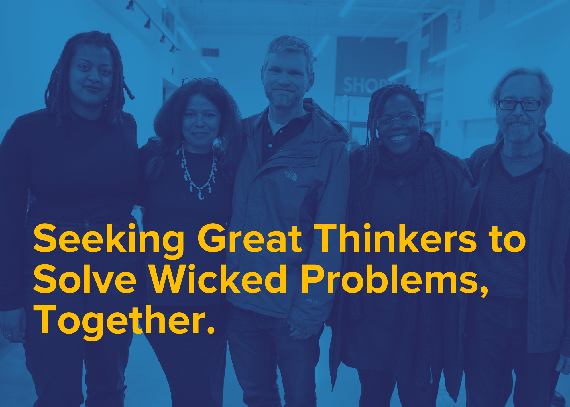 A group of five people standing together with yellow text overlay: Seeking Great Thinkers to Solve Wicked Problems, Together.