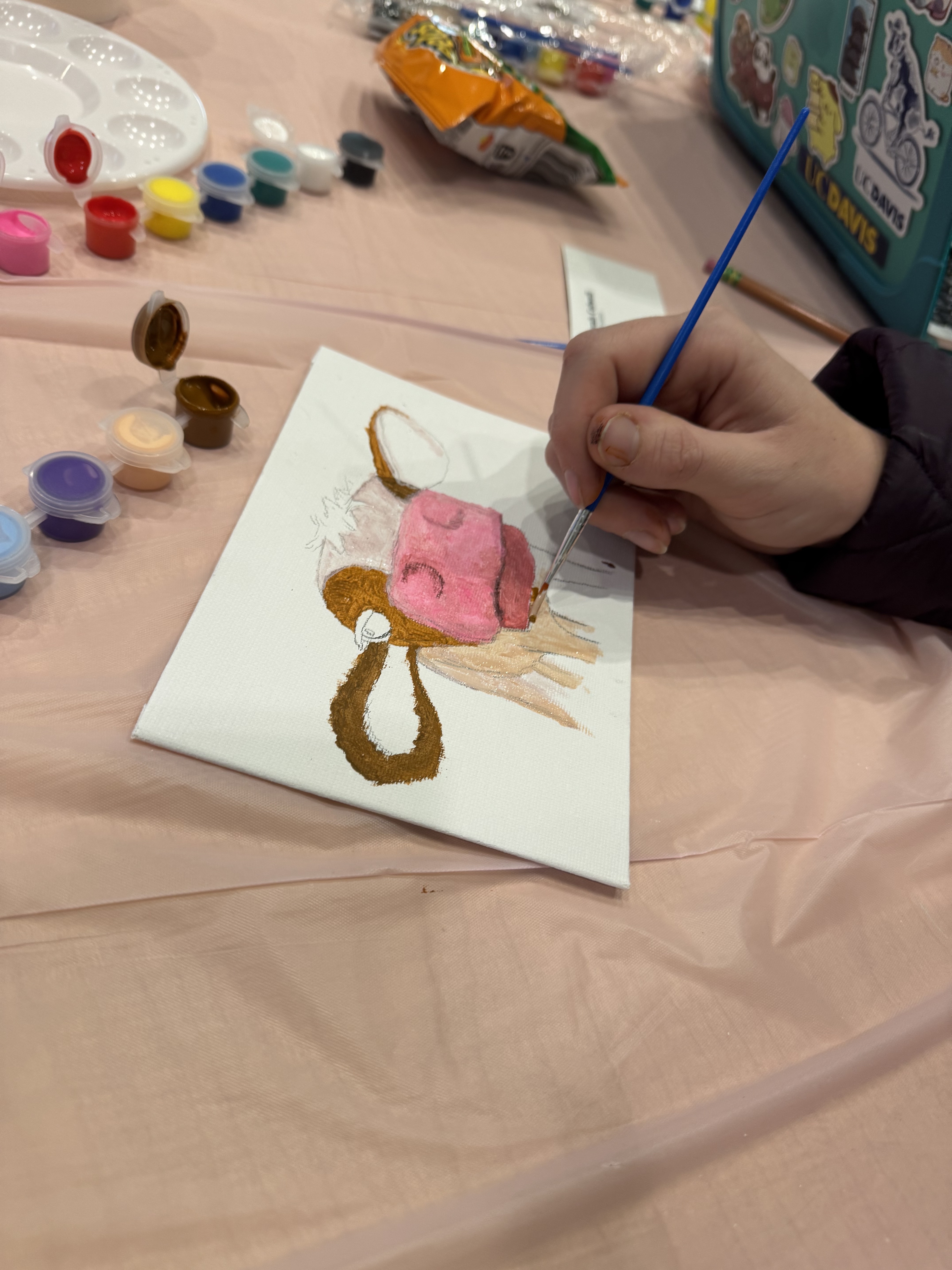 Close up image of someone painting a cow.