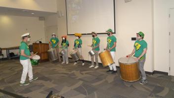 Brian Rice leads his Samba group in a musical performance