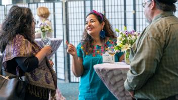 Lina Mendez chats with other audience members at the reception