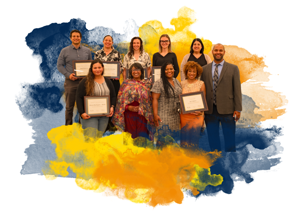 A group of ten people holding certificates, standing against a colorful watercolor background.