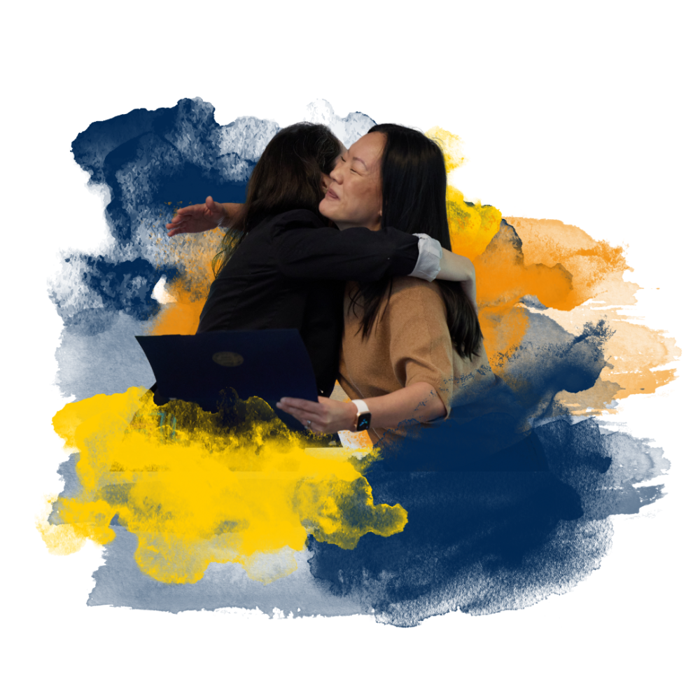 Two people embrace with a colorful artistic background.