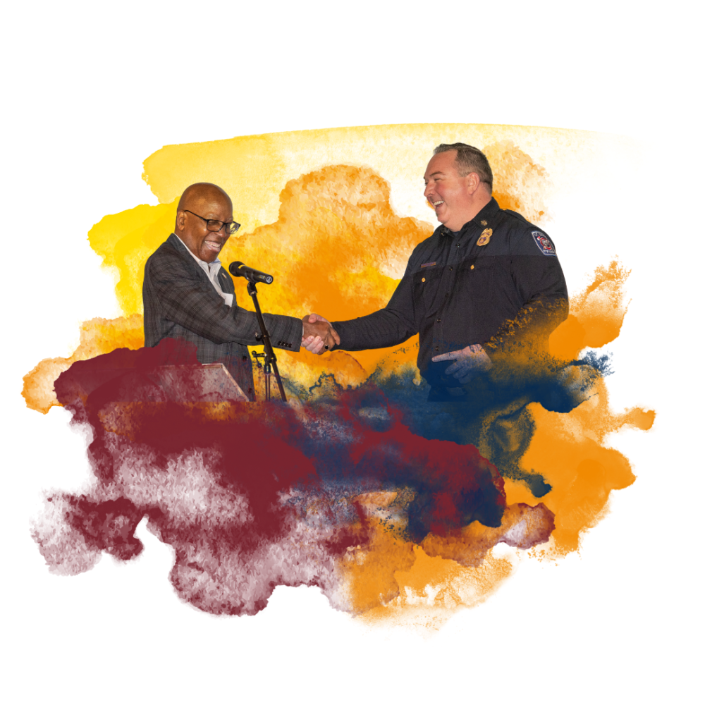 Two men shaking hands in front of a colorful, abstract watercolor background.