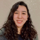 Portrait of a young woman with long curly brown hair