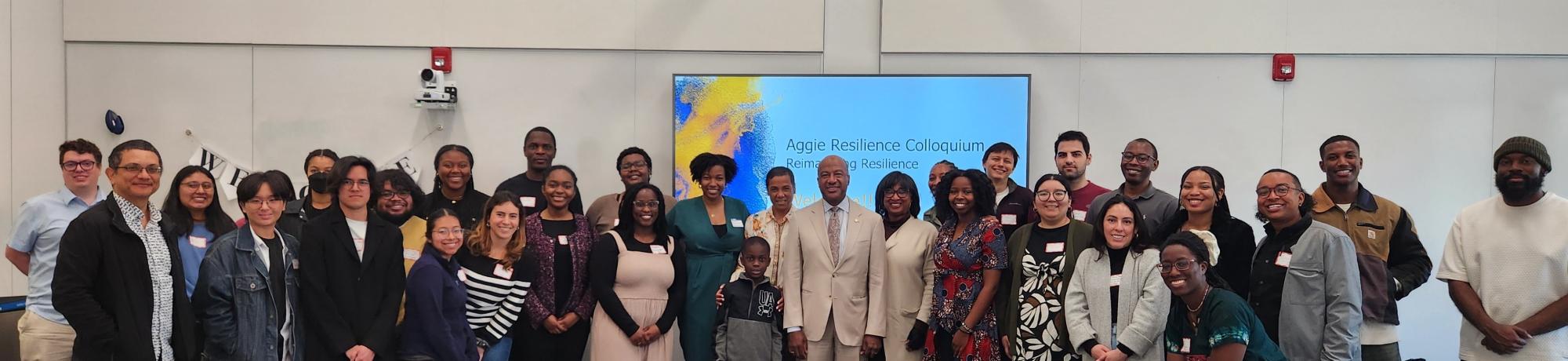 Doreen Joseph, Vice Chancellor Renetta Garrison Tull and Chancellor May stand with a group of about 30 people at Aggie Resilience event